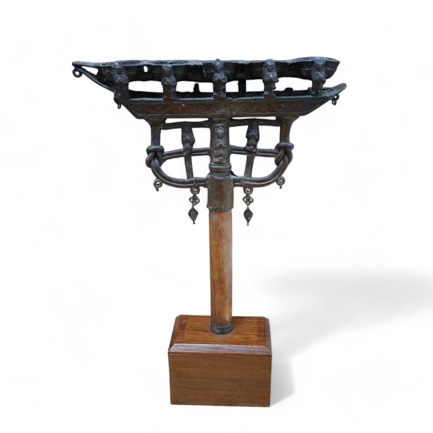 An 18th/19th century Indian Buddhist bronze oil lamp, on a later wood stand, 42.5cm high. Condition - fair